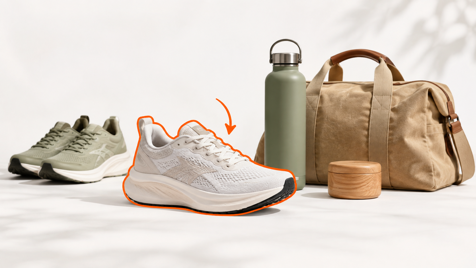 A selected hiking shoe beside a bottle, bag, and lamp in a retail still life