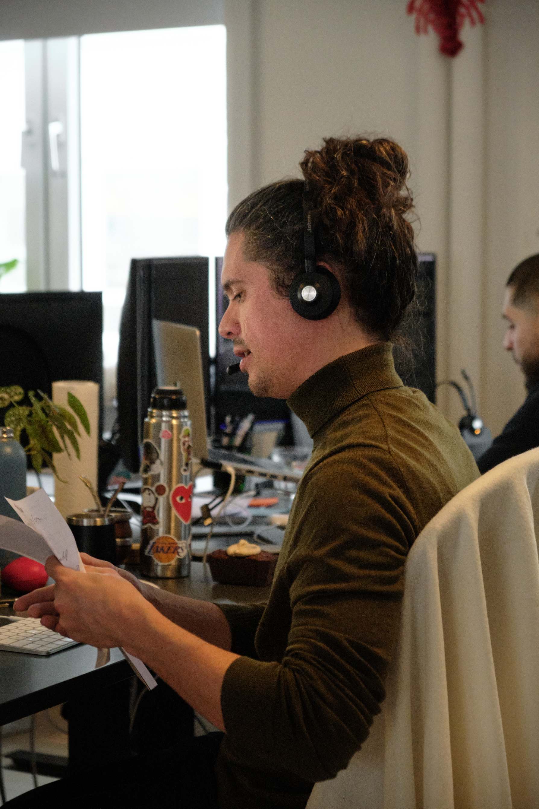 male with headset sat at a desk