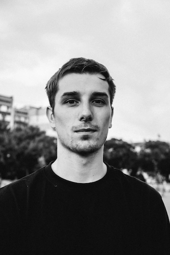 Black and white photo of a man looking at the camera.